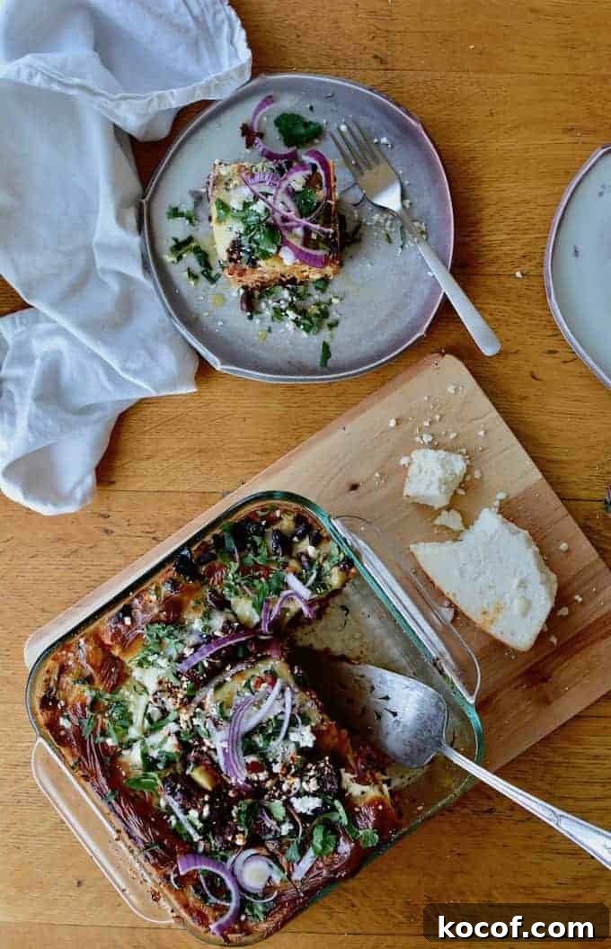 22 Delicious Easter Dinner Ideas That Aren’t Ham 7 An overhead image of a dish of enchilada casserole with a piece sitting on a plate off to the side.