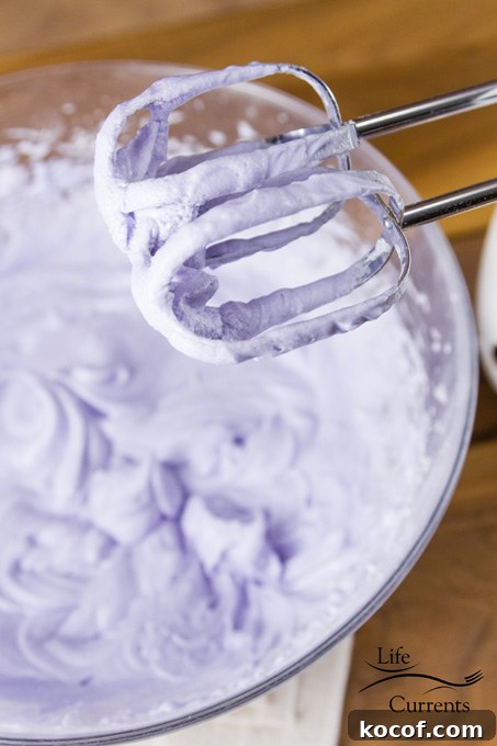 Aunt Lois’ Wedding Cake Frosting Recipe - purple frosting on beaters and in the bowl