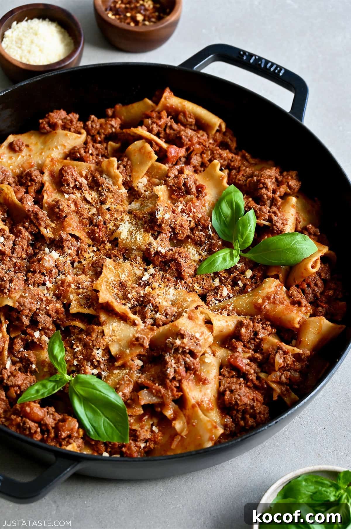 One-Pan Skillet Lasagna Recipe for Quick Weeknight Dinners 11 Easy skillet lasagna garnished with fresh basil leaves and grated Parmesan cheese.