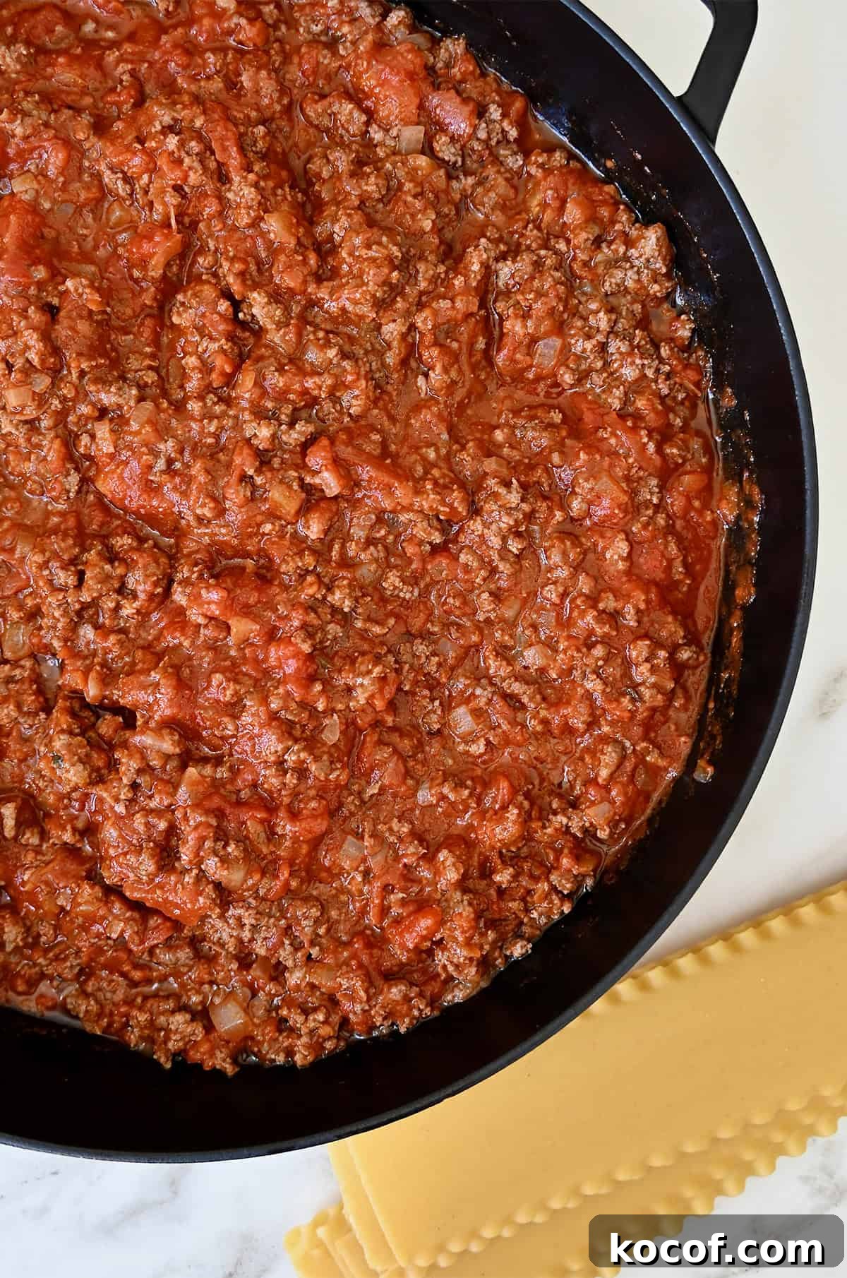 One-Pan Skillet Lasagna Recipe for Quick Weeknight Dinners 7 Lasagna noodles next to a large pan with bolognese sauce.