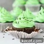 Indulgent Chocolate Mint Cupcakes with Creamy Mint Frosting 6 chocolate mint cupcake with the wrapper peeled off and more cupcakes in the background