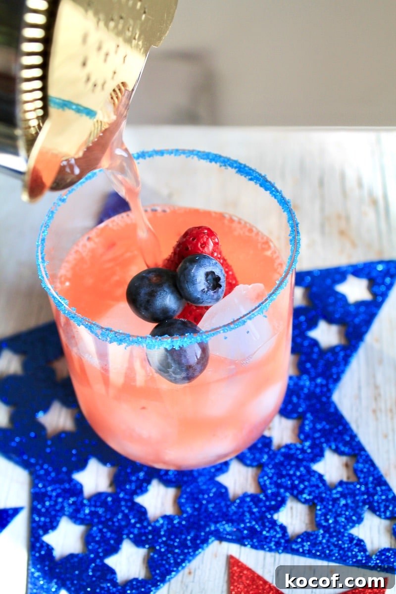 combine crushed strawberry vodka and lemonade in a cocktail shaker over ice and strain over fresh ice