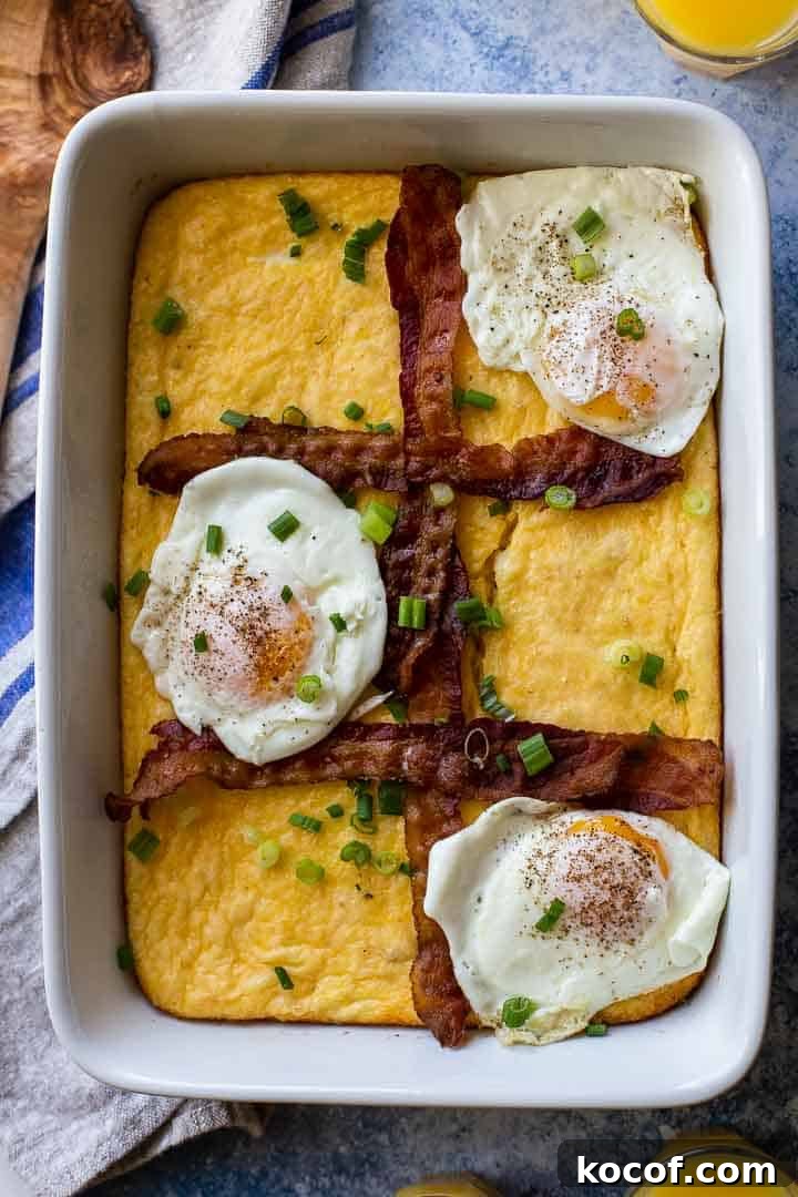 Cheesy Grits Casserole Recipe with Crispy Topping 2 white casserole pan with grits, bacon strips and 3 fried eggs