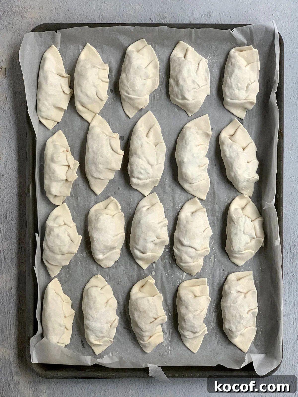 Korean Beef Mandu Dumplings Recipe: Authentic Jew Mandu Guide 14 Frozen mandu on sheet tray.