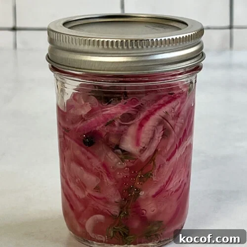 Pickled red onions in a jar.