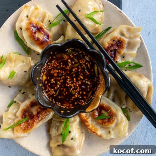 Mandu dipping sauce on a plate with dumplings.