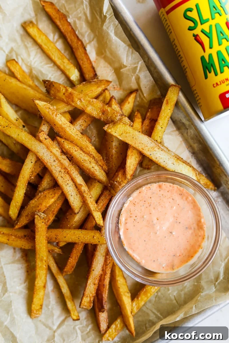 20 Delicious Side Dishes to Serve with Sliders 12 Spicy cajun fries in a tray with spicy Sriracha aioli and Slap Ya Mama cajun seasoning.