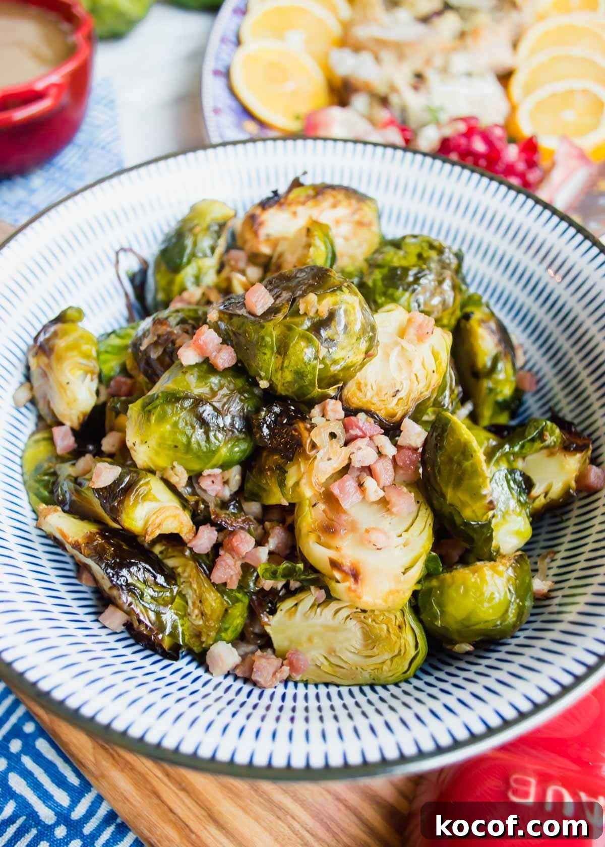 20 Delicious Side Dishes to Serve with Sliders 14 Maple Brussel Sprouts with Pancetta in bowl flatlay.