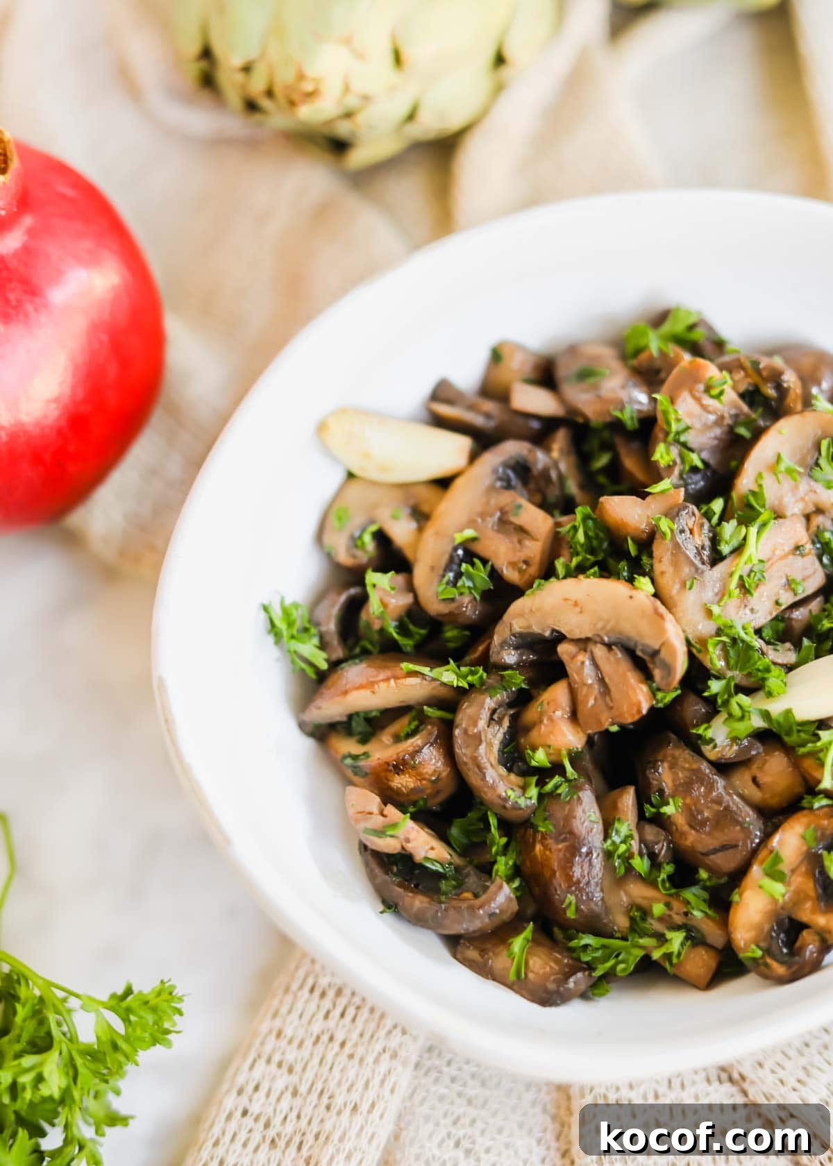 20 Delicious Side Dishes to Serve with Sliders 19 Sautéed mushrooms with White Wine in white bowl with parsley, garlic, and seasoning.