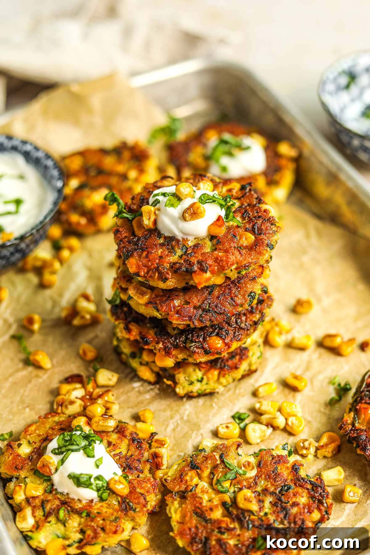 20 Delicious Side Dishes to Serve with Sliders 6 Healthy corn and zucchini fritter stacked and topped with greek yogurt, roasted corn, and basil.