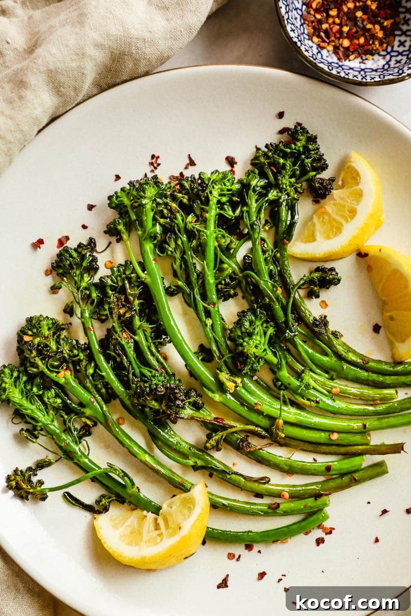 20 Delicious Side Dishes to Serve with Sliders 7 Easy delicious charred broccolini/broccoletti on a plate with seasoning, lemon wedges, and chili flakes.