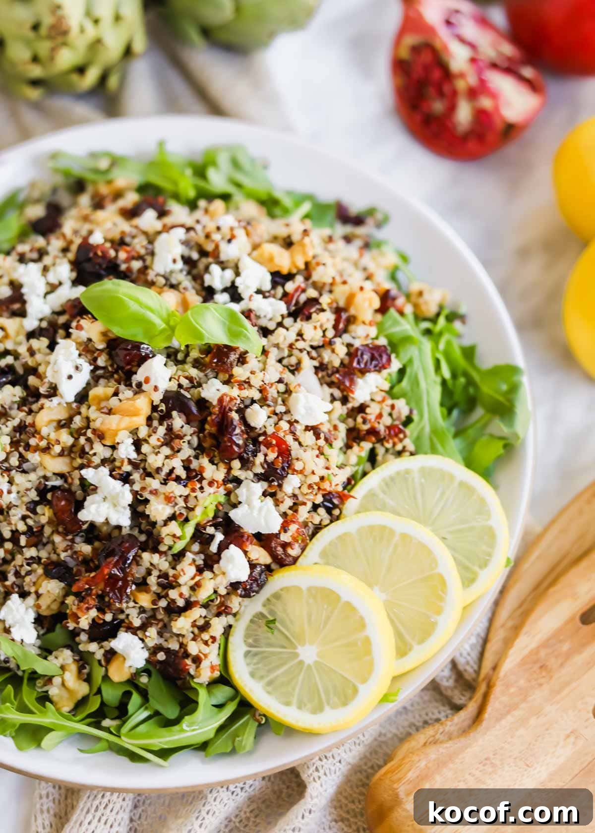 20 Delicious Side Dishes to Serve with Sliders 9 Harvest Salad with Quinoa and Arugula and lemon slices on plate.