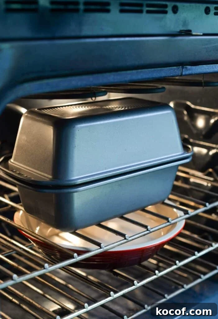 Baking Sourdough in a Loaf Pan: Step-by-Step Guide for Perfect Crust 12 Two loaf pans are tipped to form an enclosed pan in an oven.