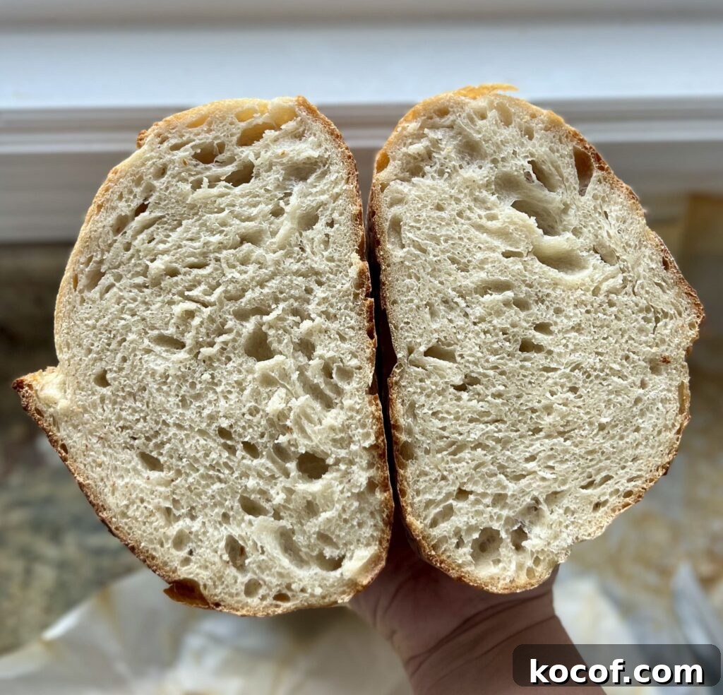 Baking Sourdough in a Loaf Pan: Step-by-Step Guide for Perfect Crust 6 A loaf of sourdough bread has been cut in half.