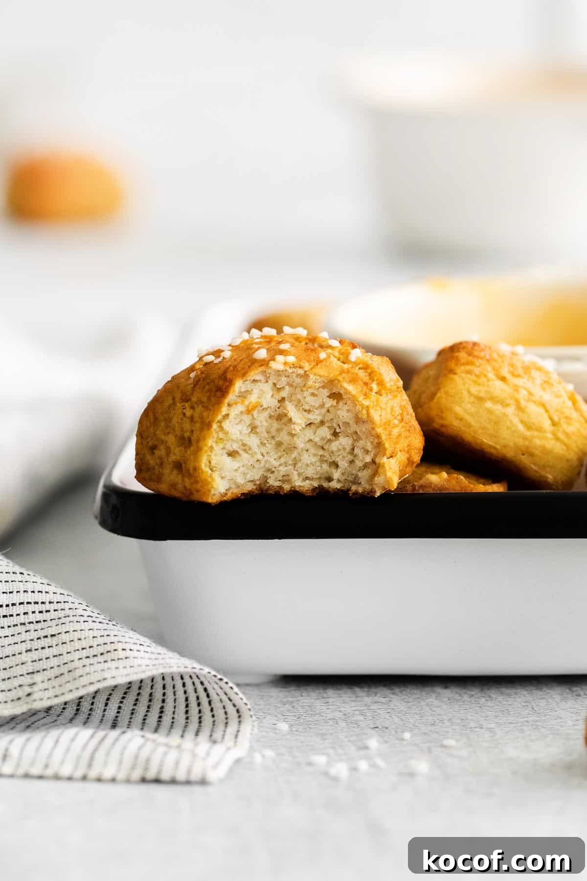 a gluten-free soft pretzel with a bite taken out of it.