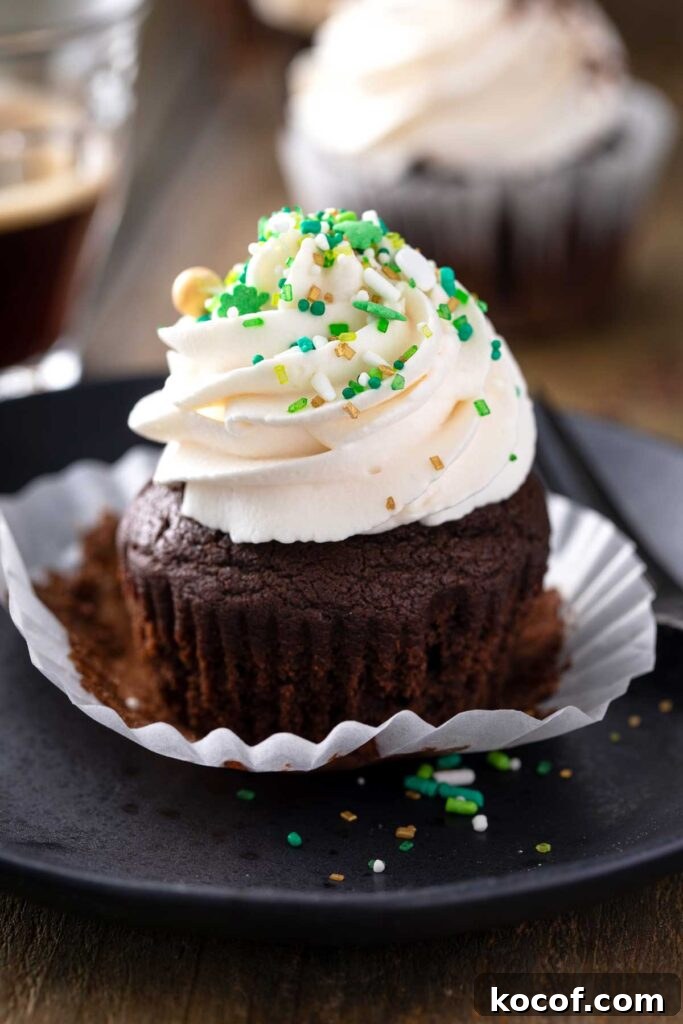Chocolate cupcake frosted and decorated with green and gold St. Patrick's day sprinkles.