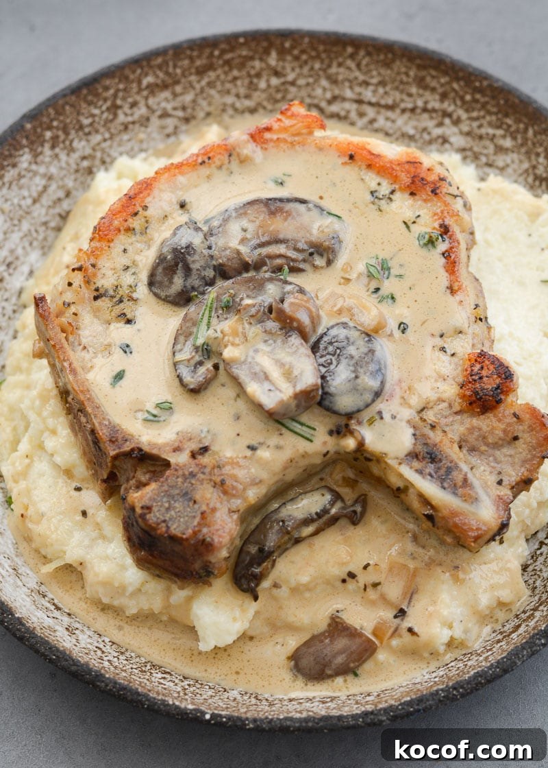 Creamy One-Pan Pork Chops with Garlic Herb Sauce 12 creamy mushroom sauce atop juicy bone-in pork chops on a bed of mashed potatoes