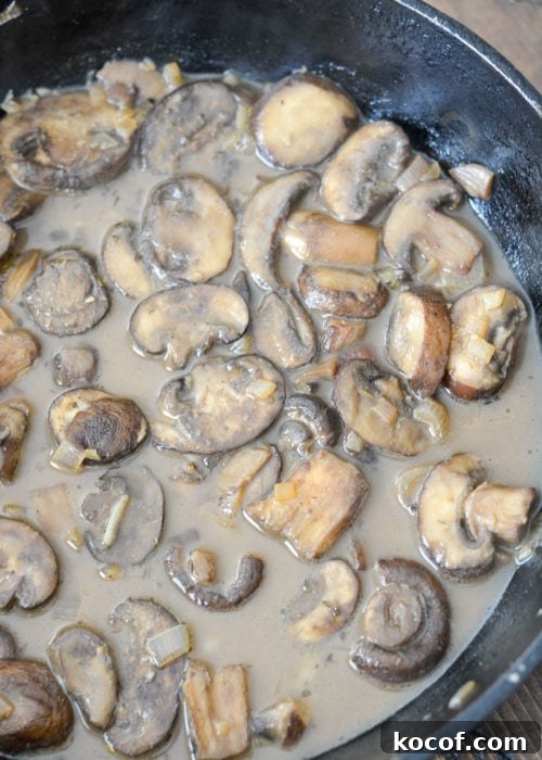 Creamy One-Pan Pork Chops with Garlic Herb Sauce 9 creamy mushroom sauce in a cast iron skillet