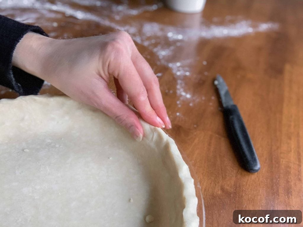 Flaky All-Butter Pie Crust Recipe for Perfect Pastry 6 Crimping the edges of the pie crust