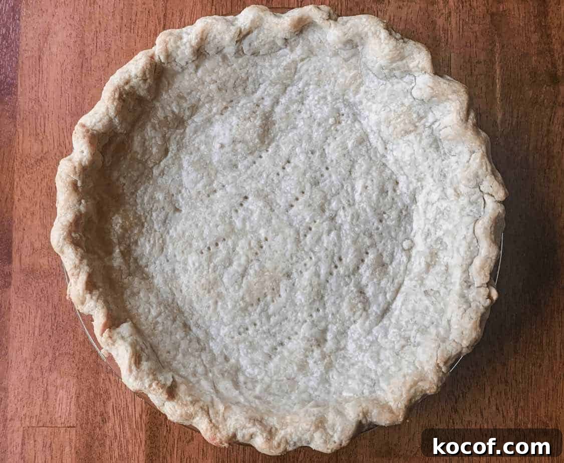 Flaky All-Butter Pie Crust Recipe for Perfect Pastry 9 A prebaked pie crust in a pie dish