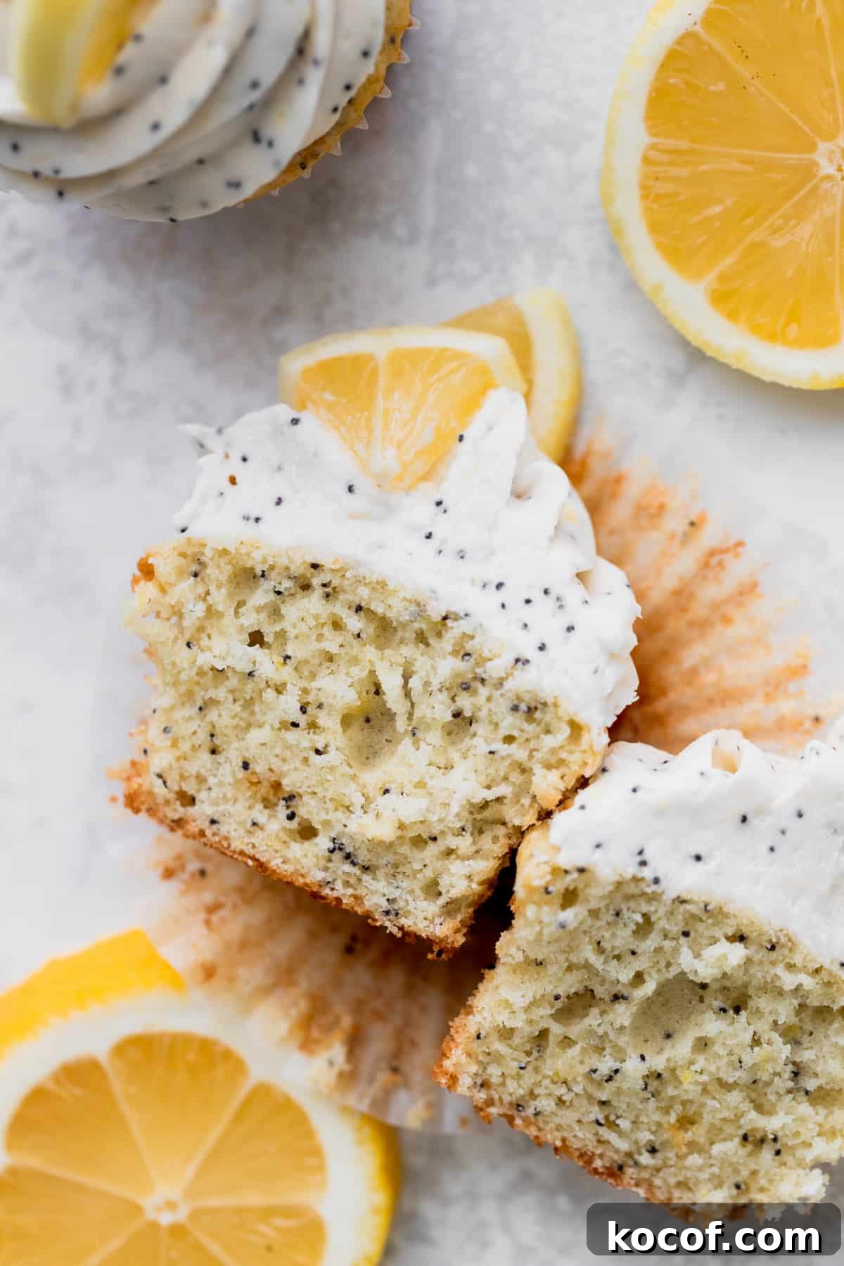 Lemon Poppy Seed Cupcakes with Zesty Glaze and Moist Crumb 2 Lemon poppy seed cupcakes split in half.