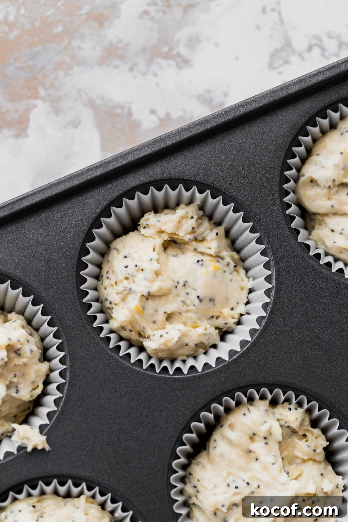 Lemon Poppy Seed Cupcakes with Zesty Glaze and Moist Crumb 6 Cupcake batter in a muffin tin.