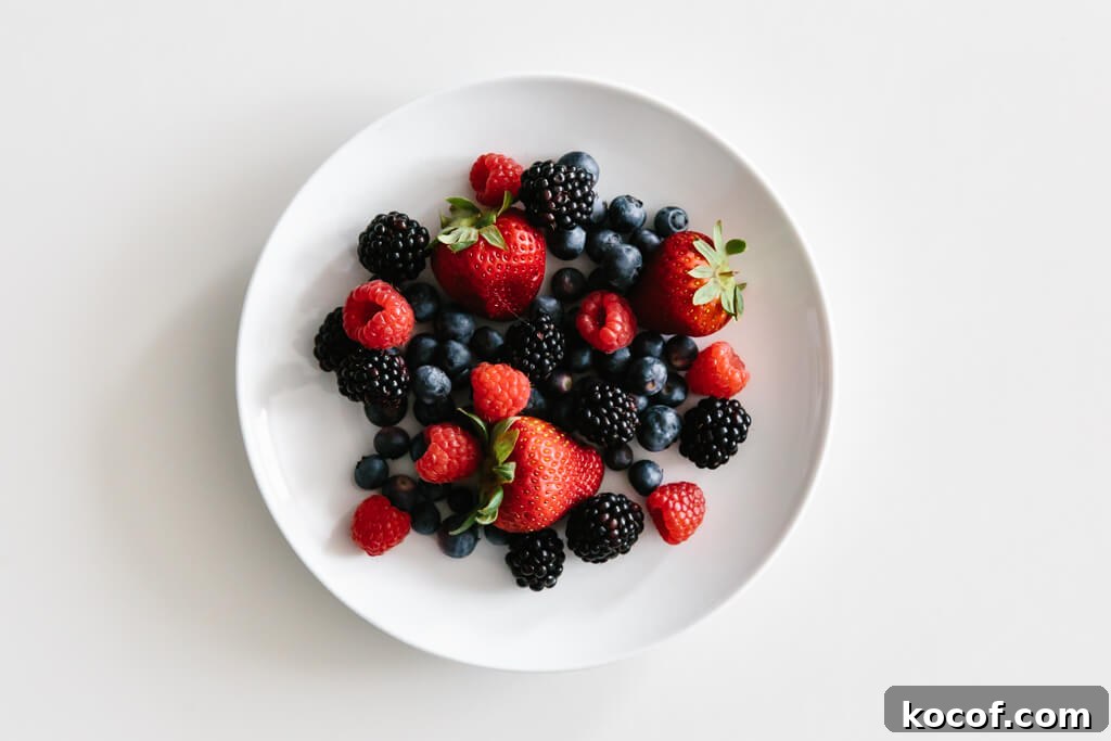 Plate of berries on a white table.