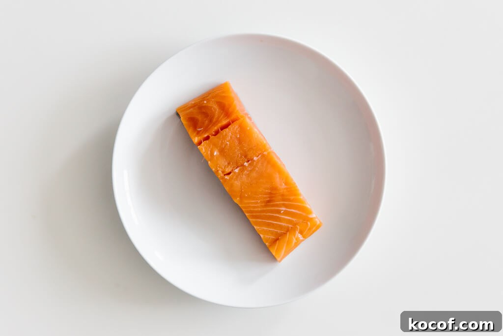 Plate of salmon on a white table.
