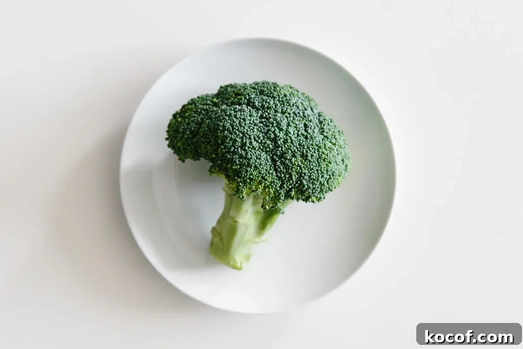 Plate of broccoli on a white table. 
