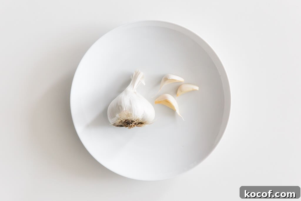 Plate of garlic on a white table. 