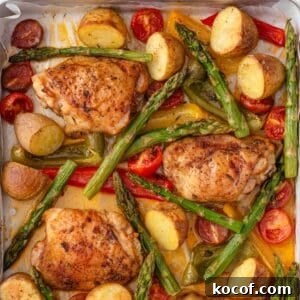 Crispy Herb-Roasted Chicken Thigh Tray Bake with Vegetables 14 Roasted chicken thighs with vegetables on a pan.