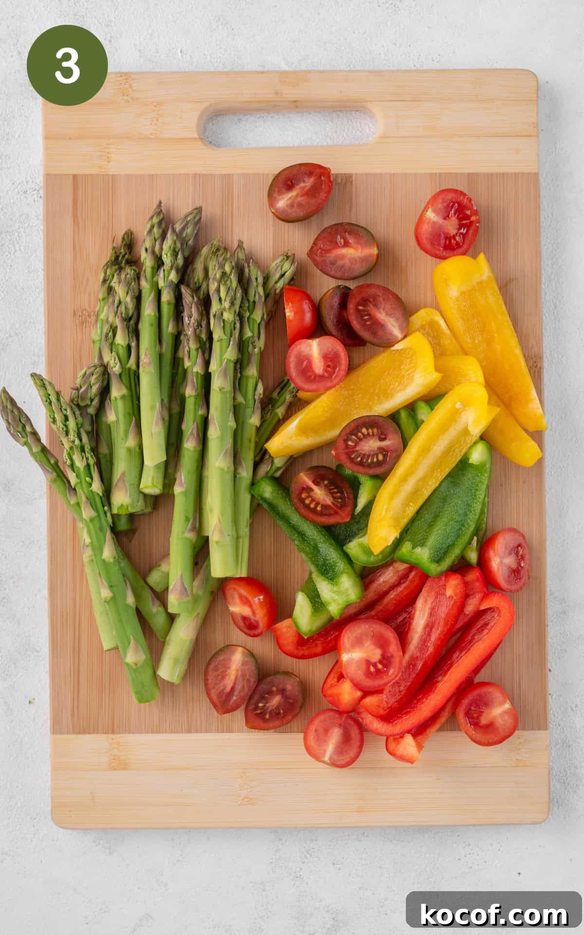 Crispy Herb-Roasted Chicken Thigh Tray Bake with Vegetables 6 Vegetables on a cutting board.