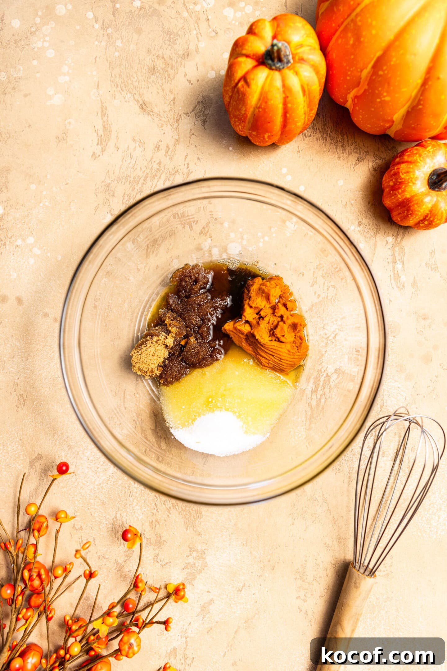 Brown Butter Pumpkin Snickerdoodle Cookies — Soft & Chewy 4 Brown butter, sugars, and pumpkin in a mixing bowl next to a whisk.