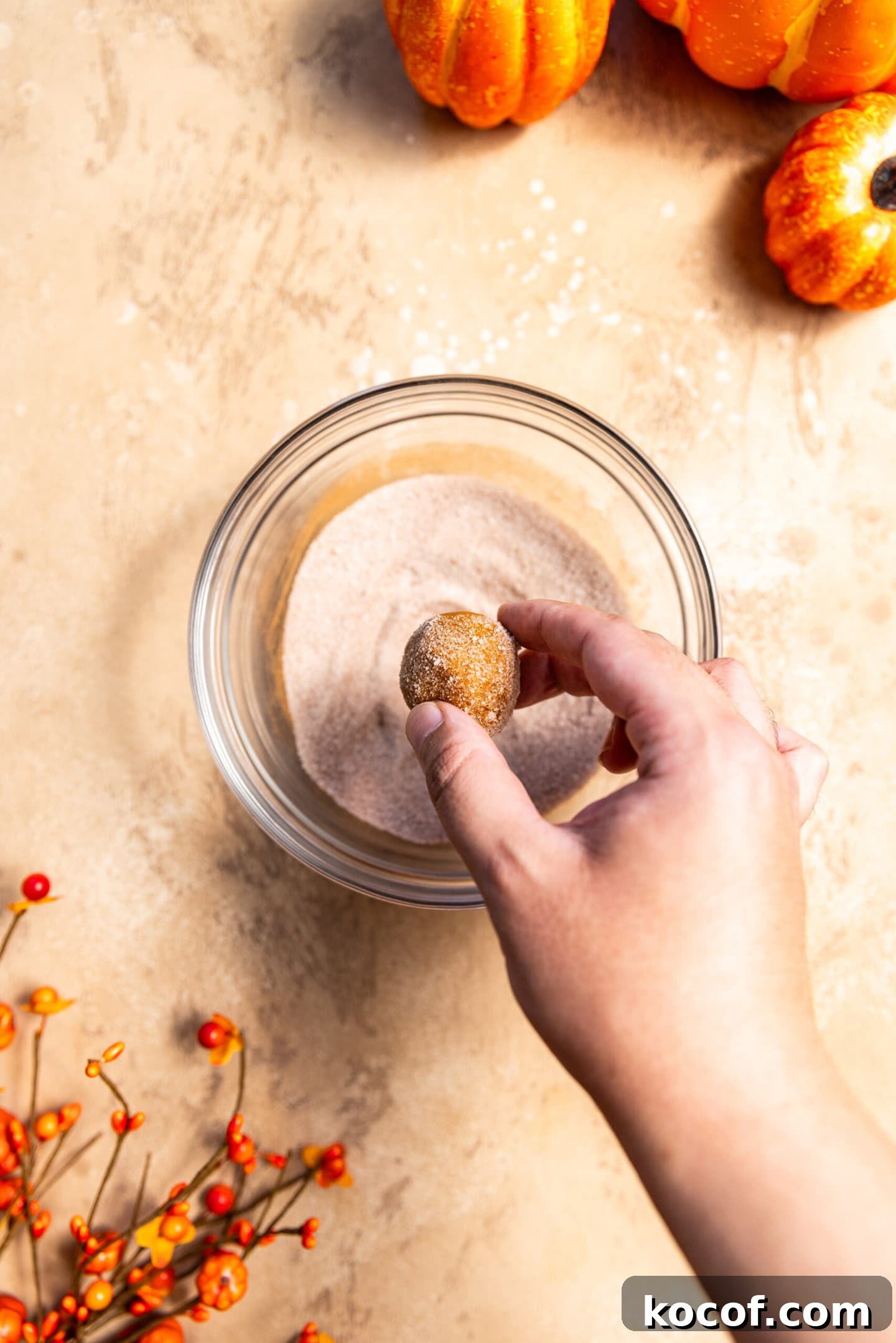 Brown Butter Pumpkin Snickerdoodle Cookies — Soft & Chewy 9 Cookie dough being rolled in spiced cinnamon sugar mixture.