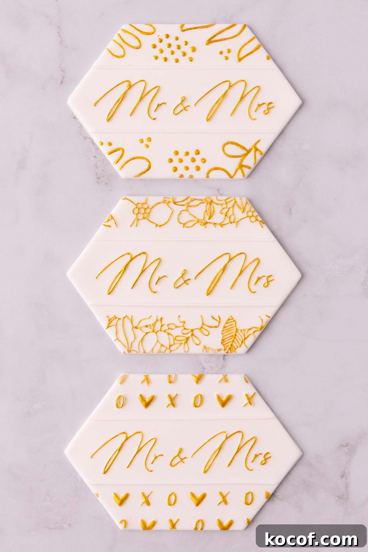 Make Edible Gold Paint at Home: A Step-by-Step Guide 16 Three stamped fondant designs painted with gold paint, all three say "Mr & Mrs" in the centre, and they have different floral designs around the edges.