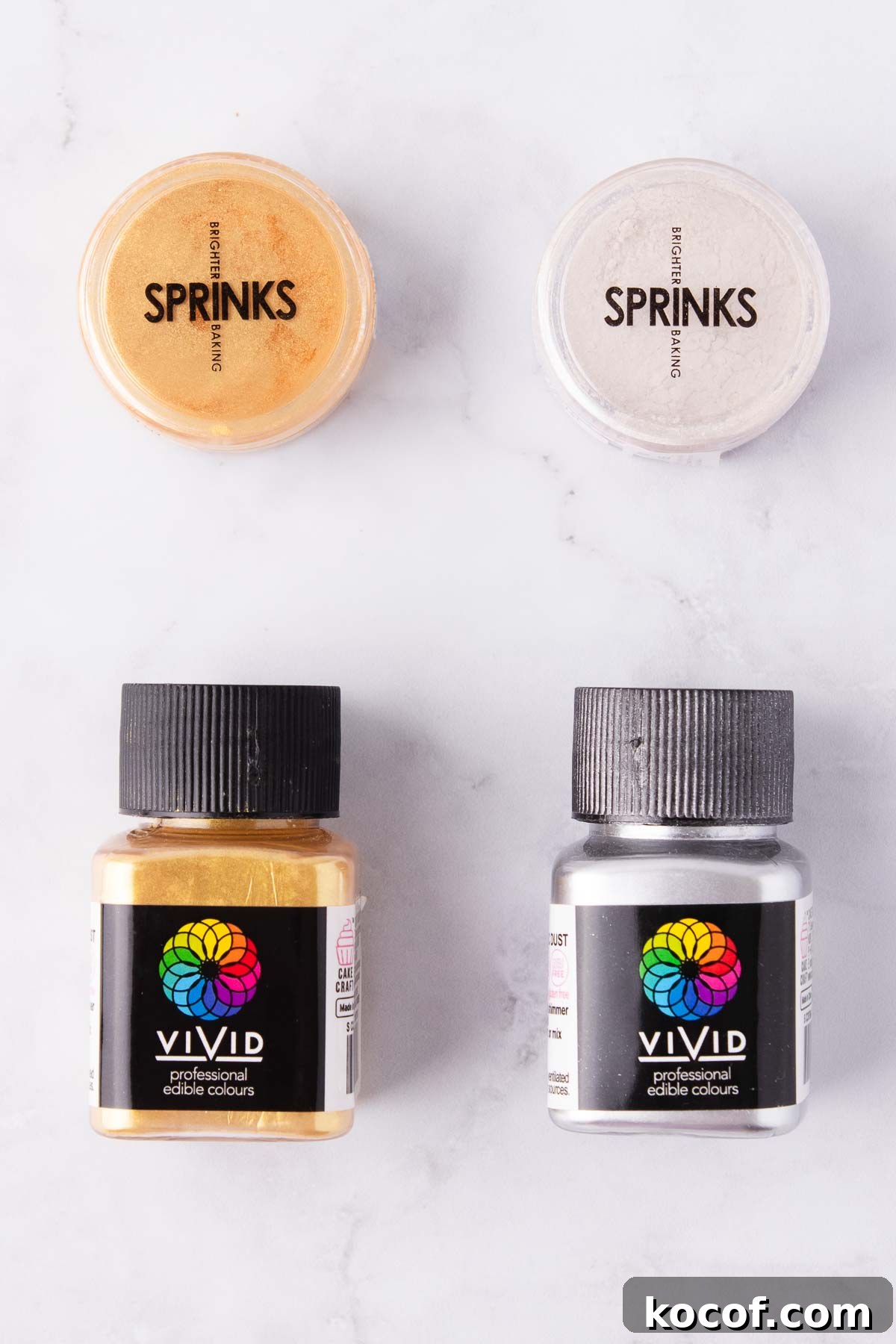 Make Edible Gold Paint at Home: A Step-by-Step Guide 4 Small containers of edible gold lustre dust on a grey marble background.