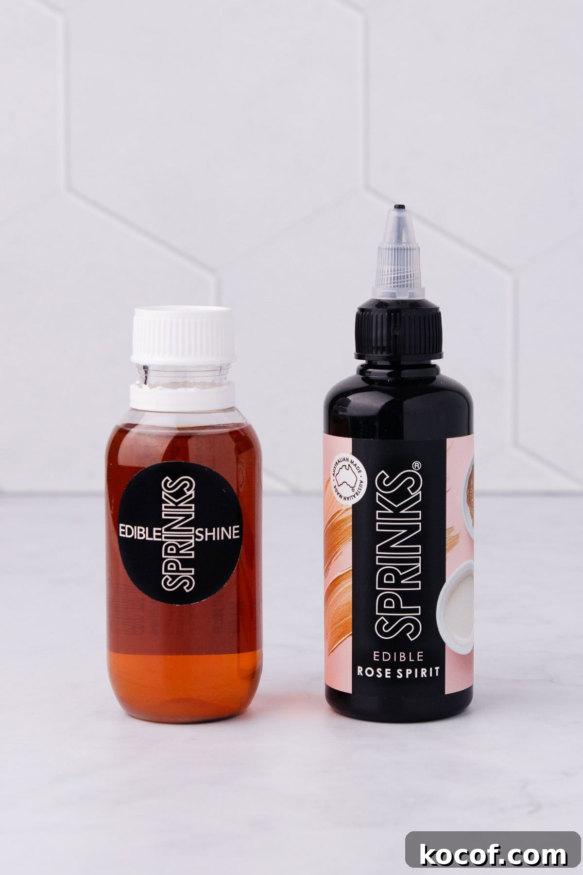 Make Edible Gold Paint at Home: A Step-by-Step Guide 5 A bottle of Sprinks Confectioner's glaze and rose spirit on a grey marble background.