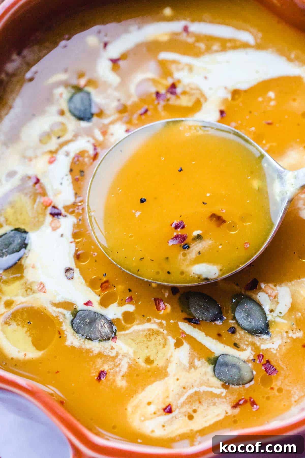 Creamy Autumn Pumpkin Soup Recipe for Cozy Dinners 6 Vegan Pumpkin Soup garnished with fresh thyme, child flakes and pumpkin seeds