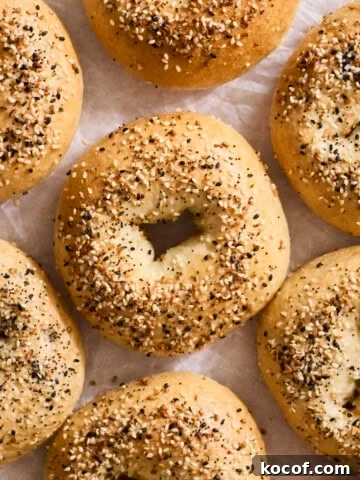 Homemade Everything Bagels on white parchment paper.