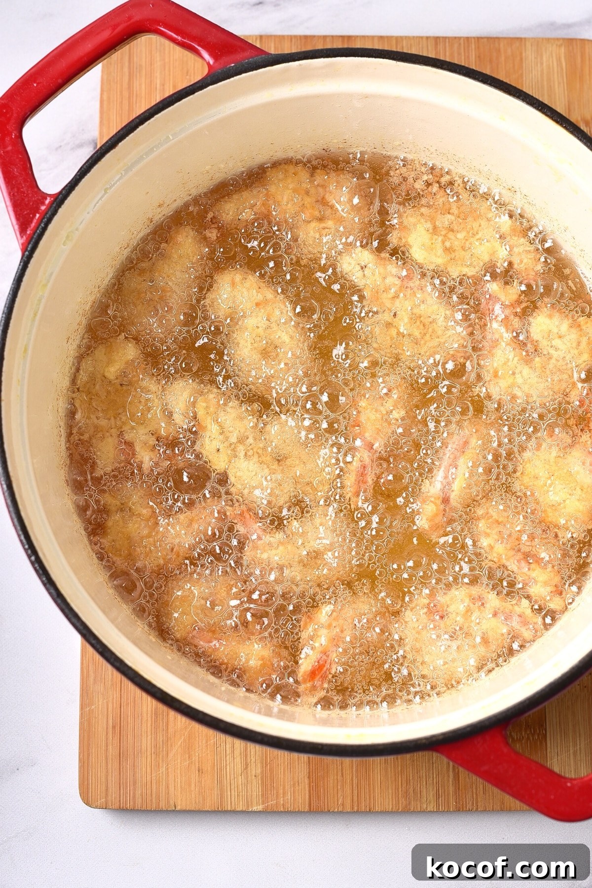 Dairy-Free Coconut Shrimp (Gluten-free) Deep-frying gluten-free coconut shrimp in a pot of oil.