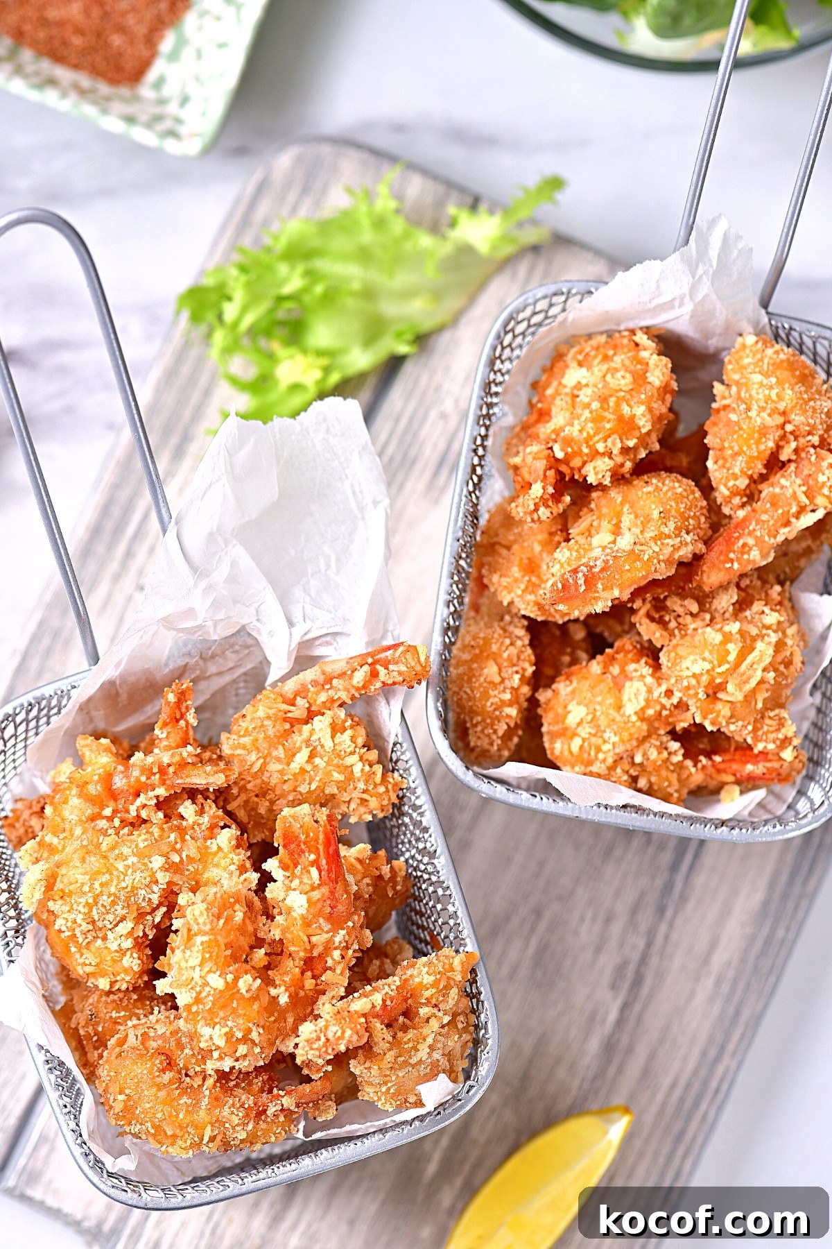 Gluten-Free Coconut Shrimp Recipe (dairy-free) Top down view of baskets of coconut shrimp.