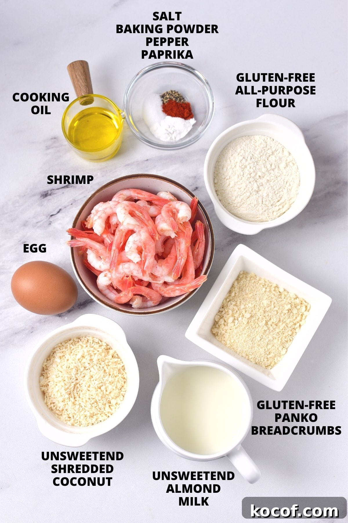 Crispy Coconut Shrimp (Gluten-Free, Dairy-Free) Ingredients for crispy coconut shrimp recipe laid out on marble board.