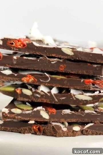 Pieces of dark chocolate bark stacked on top of one another.