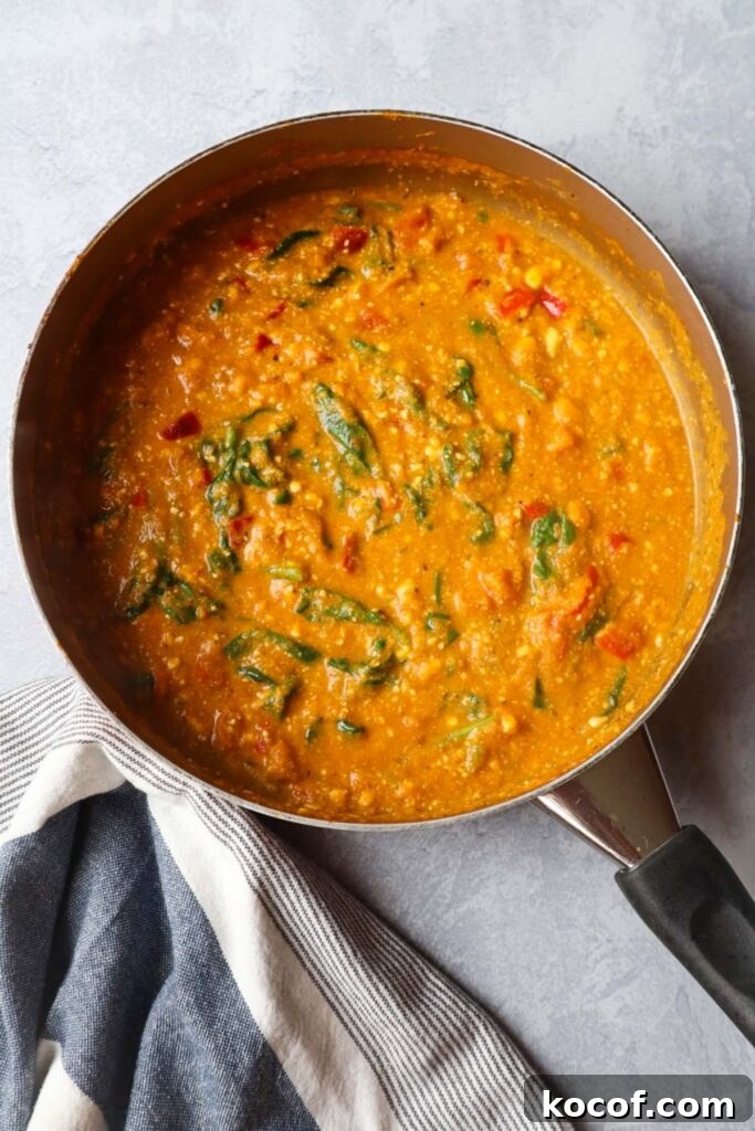 skillet with pumpkin feta sauce with spinach and red bell pepper