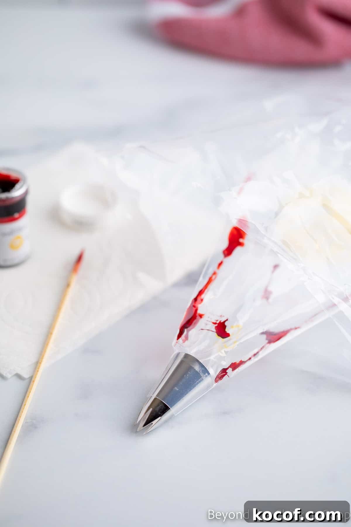 Lining a pastry bag with red food coloring.