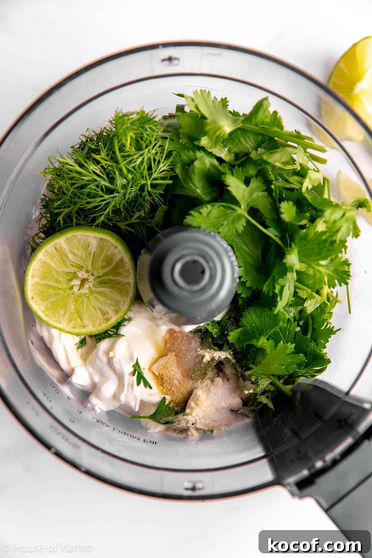 Food processor filled with ingredients for cilantro lime ranch dressing.