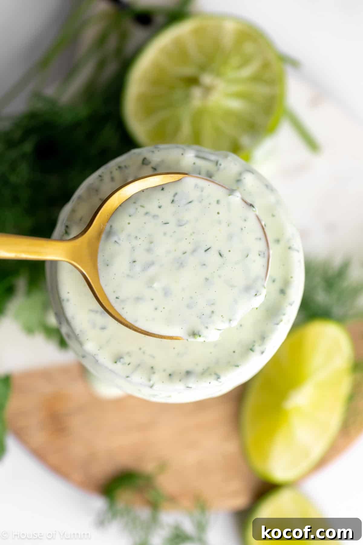 Cilantro lime ranch in a jar with a spoon scooping it up.