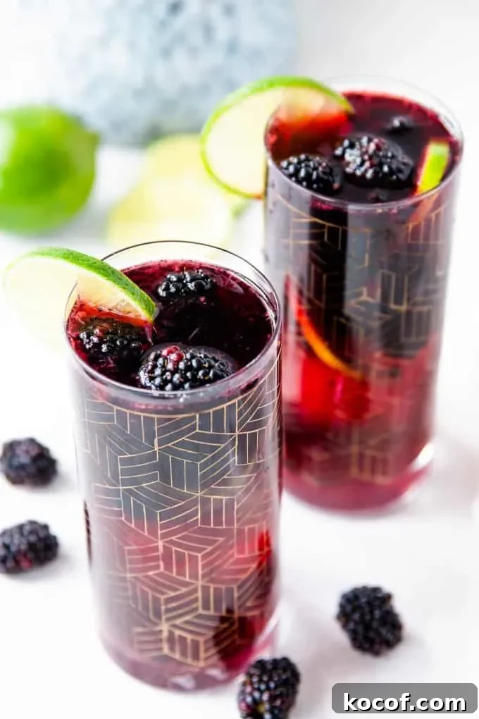Blackberry Sangria with Blackberry Brandy: Simple Refreshing Recipe 5 two glasses blackberry sangria garnished with lime slices