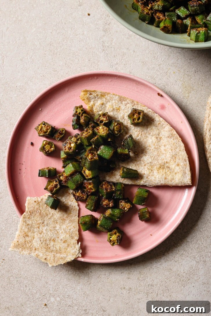 Partially eaten plate of Bhindi Fry with roti.