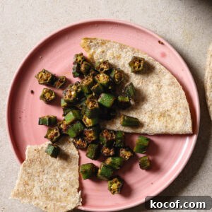 Partially eaten plate of Bhindi Fry with roti.